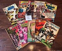 Photo showing all ten comic books laid out in two rows, visually confirming the variety and condition of the comics.