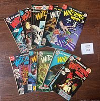 Lot of 10 DC "The Witching Hour" comic books arranged on a wooden floor, showing various cover artworks with horror themes and DC logos, with a maxsold lot card number 103.