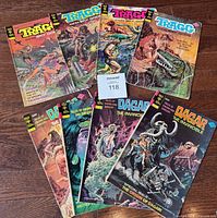 Eight comic books displayed in two rows, four Dagar the Invincible and four Tragg and the Sky Gods issues.