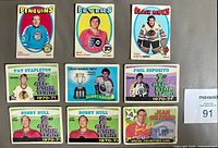 Front of all 9 hockey cards showing players, team names and designs.