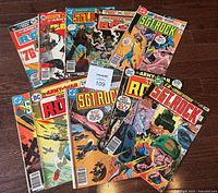 View of full lot of 10 D.C. Comics Sgt. Rock comic books with colorful war-themed covers arranged on the floor.