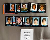 Top view of multiple 1985-86 NHL 7-Eleven plastic hockey cards face up showing players including Tim Kerr, Brian Bellows, Ron Duguay, Steve Yzerman, Mario Lemieux, Mike Bullard.