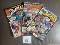 Photo of all three Madballs Star Comics limited series comic books from 1986, issues #1, 2, and 3, showing front covers with colorful cartoon horror-themed characters and series branding.