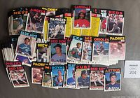 Top-down photo showing an assortment of high-grade 1986 OPC baseball cards from various teams including Mets, Angels, Padres, Yankees, Reds, Phillies, Red Sox, Royals, Cubs, Astros, among others.