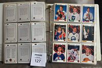 Binder pages showing hockey cards front and back, arranged in sleeves, with player photos and text.