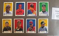 Front view of 8 signed and numbered 1995 Old Judge Signature Rookies baseball cards featuring player portraits and team colors.