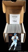 Open box filled with a complete set of 125 Pinnacle Select Certified football cards featuring John Elway on the front card.