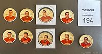 Photo of front sides of nine Detroit Red Wings hockey coins from 1961-62 showing players including Terry Sawchuk and Alex Delvecchio.