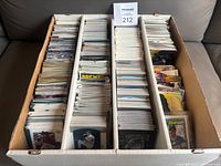 Wide view of an open box packed with neatly arranged baseball cards in rows.