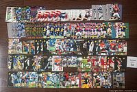 Several rows of 1996 NFL football trading cards spread on a surface. Cards depict various NFL players in different poses, showing front card art and design, including star players and rookies.