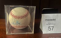 Signed baseball inside custom Lucite display case, showing signature and holder