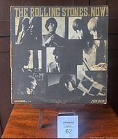 Front cover of The Rolling Stones Now! 1965 LP showing black and white portraits of band members with noticeable wear and edge damage