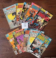 All ten Jonah Hex comic books displayed laid out on a wooden floor, showing front covers with various action scenes and character artwork.