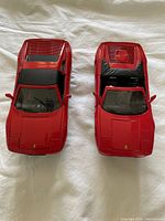 Top view showing two red Ferrari model cars, side by side.