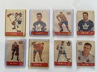 Top-down image of 8 Parkhurst 1955-56 hockey cards featuring various NHL players, showing card fronts with noticeable wear and creases.