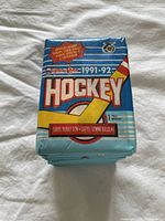 Single unopened OPC 1991-92 hockey trading card pack showing front wrapper with vintage graphics.