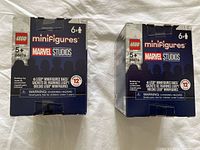 Front view of two unopened LEGO Marvel Studios minifigures boxes with 6 minifigures each