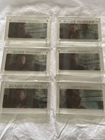All six Blade Runner hologram cards in original plastic holders laid out on white fabric, showing different characters and scenes from the movie.