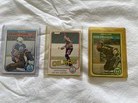 Lot of three OPC rookie hockey cards in protective sleeves: Grant Fuhr, Jari Kurri, and Ron Francis.