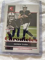 Front of 2021 Chronicles Derek Carr football card numbered 249/399 featuring Las Vegas Raiders QB.