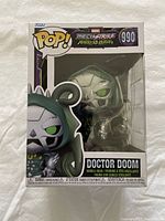 Photo of Funko POP! Doctor Doom Mechstrike Monster Hunter figure in original packaging, showing character design and box details.