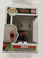 Funko Pop! boxed figure of Drax from Guardians of the Galaxy Holiday Special, showing the front of the box with item number 1106 and the character visible inside.