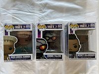 Three Funko POP! figures in original boxes from Marvel What If? series: Queen General Ramonda, Zombie Falcon, and Infinity Killmonger.