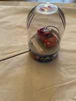 Mini Master Racer RC car in clear plastic dome packaging with visible antenna and blue base.