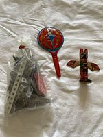 Photo of all three items shown: Steel Tec parts bag, wooden totem, vintage noisemaker