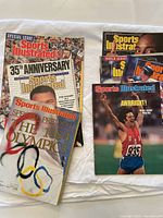 Lot of 7 vintage Sports Illustrated magazines, including 35th Anniversary issue, 1984 Olympics Special Preview, and a Bruce Jenner cover