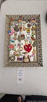 Full view of tray showing all brooches and pins
