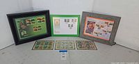 Overall view of three framed stamp displays and three loose sheets