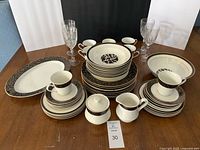 Full dinnerware set with serving pieces and goblets displayed on table