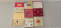 Overview of all five boxed miniature perfume sets laid out on surface