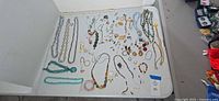 Full lot overview on table showing mixed jewelry pieces