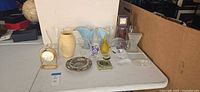 Overall lot showing vases, clocks, paperweights, dish