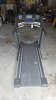 Full view of NordicTrack Elite 3200 treadmill folded flat, belt and frame visible