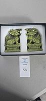 Pair of jadeite dragon figurines in foam-lined box