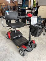 Full view of scooter with basket, manuals, charger visible