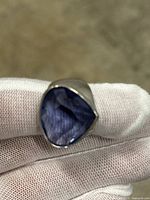 Close-up of the ring front showing the large blue triangular faceted stone set in sterling silver.