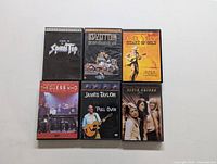 Photo showing six concert DVDs from various artists arranged in a grid, including Scorpions, Led Zeppelin, Neil Young, The Guess Who, James Taylor, and Dixie Chicks.