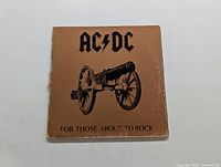 Front cover of AC/DC LP showing cannon image and album title