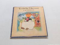 Front cover of the vinyl LP Tea for the Tillerman by Cat Stevens, showing the illustrated artwork with a man at a tea table under a tree.