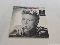 Front album cover photo showing black and white portrait of David Bowie with title text.