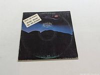Front cover of Electric Light Orchestra II vinyl LP album showing wear and track highlights sticker.