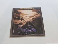 Front cover of the Jackson Browne "Running on Empty" LP showing road and drum set artwork.