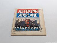 Front cover of Jefferson Airplane LP 'Takes Off' showing band members and album title.