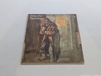 Front cover of Jethro Tull Aqualung LP showing the featured artwork of a man on a street corner.