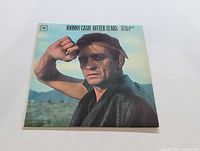 Front cover of the Johnny Cash Bitter Tears LP showing Johnny Cash posing with fist near head.
