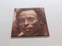 Front view of album cover showing grainy sepia portrait of Miles Davis.